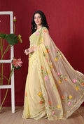 Pastel yellow chiffon saree with Ari Buta embroidery, front view