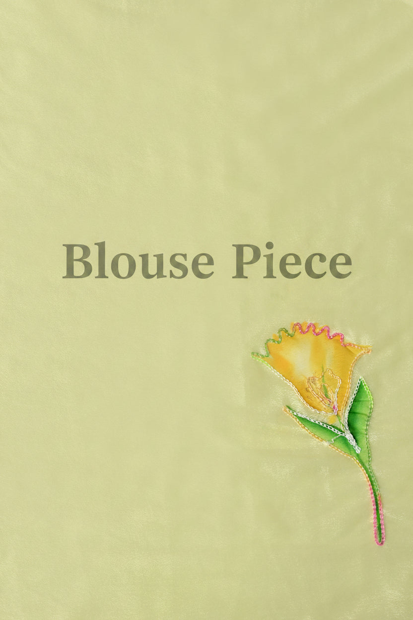 A pale yellow fabric swatch with the words 'Blouse Piece' printed in gray serif text and a small embroidered yellow flower with green leaves in the lower right corner.